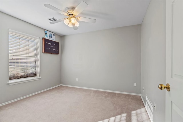 carpeted spare room with ceiling fan