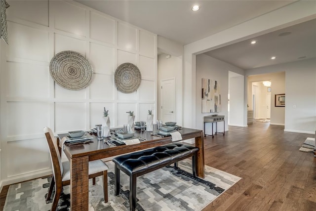 dining space with wood-type flooring