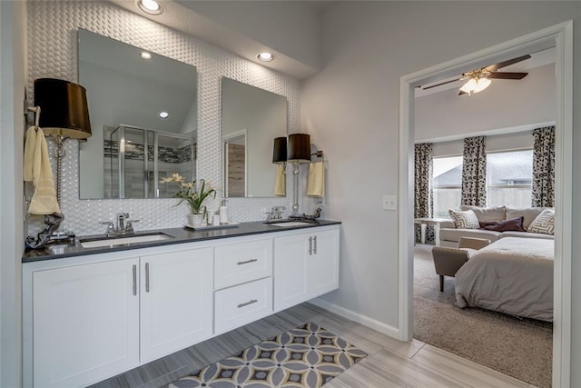 bathroom featuring backsplash, vanity, ceiling fan, hardwood / wood-style flooring, and a shower with shower door