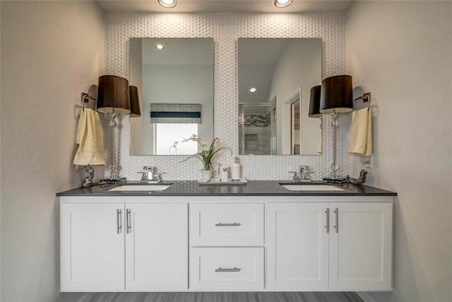 bathroom featuring tasteful backsplash, vanity, and hardwood / wood-style flooring