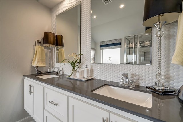 bathroom with tasteful backsplash and vanity