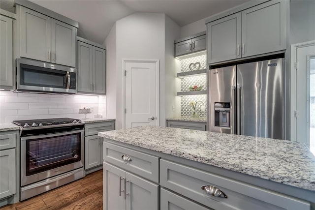 kitchen featuring gray cabinetry, dark wood-type flooring, and appliances with stainless steel finishes