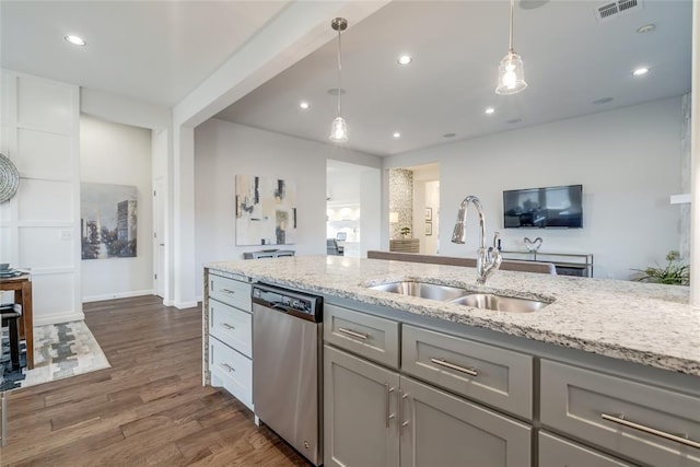 kitchen with gray cabinetry, sink, light stone counters, stainless steel dishwasher, and dark hardwood / wood-style floors