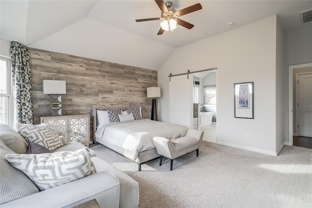 carpeted bedroom featuring ceiling fan, a barn door, wooden walls, and multiple windows