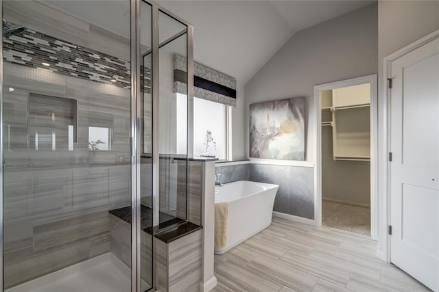 bathroom featuring shower with separate bathtub and vaulted ceiling