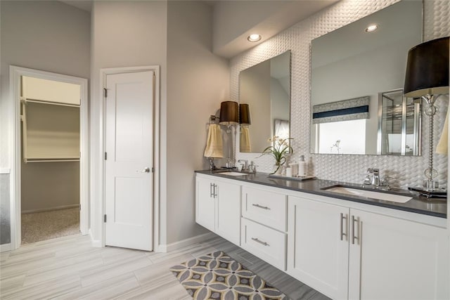 bathroom with decorative backsplash and vanity