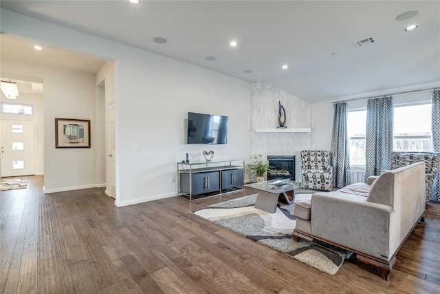 living room with a fireplace and dark hardwood / wood-style floors