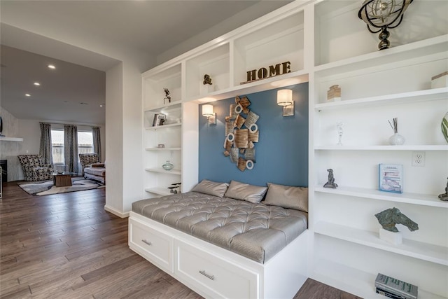 mudroom with hardwood / wood-style floors and built in shelves