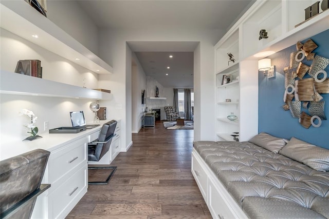 bedroom featuring built in desk and dark hardwood / wood-style floors