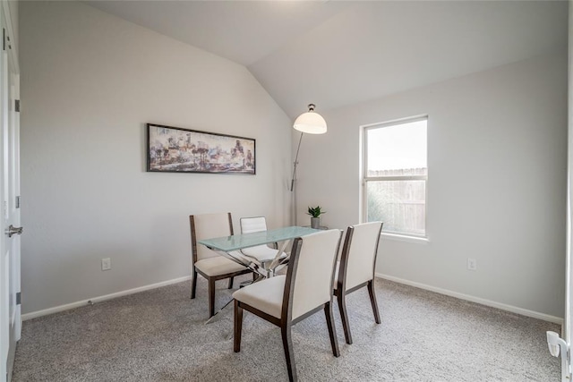 dining room featuring lofted ceiling and carpet floors