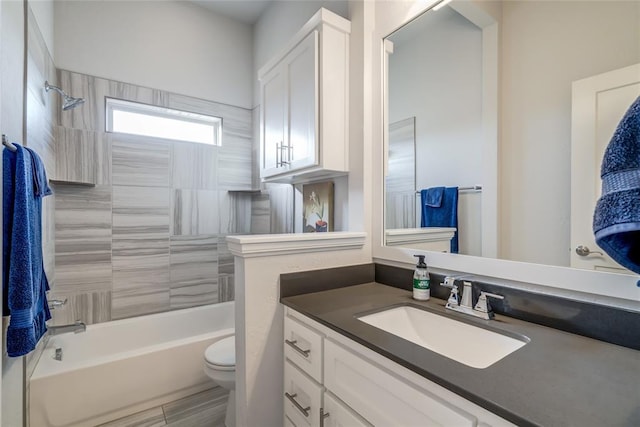 full bathroom featuring vanity, toilet, and tiled shower / bath