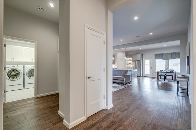 corridor featuring dark hardwood / wood-style floors and washing machine and clothes dryer