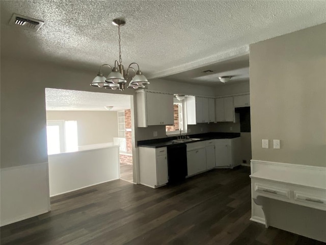 kitchen with dark wood-type flooring, pendant lighting, a chandelier, black dishwasher, and white cabinetry