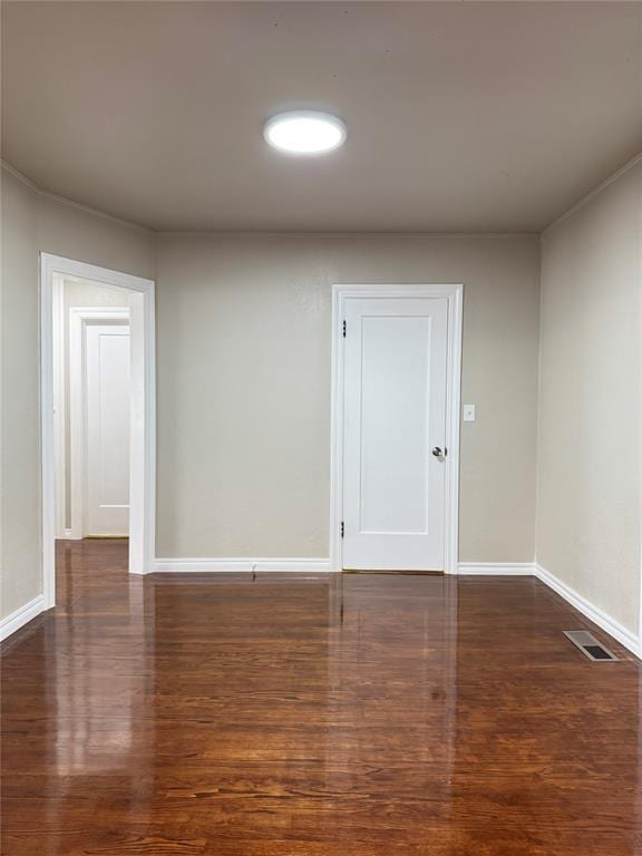 empty room featuring dark wood-type flooring