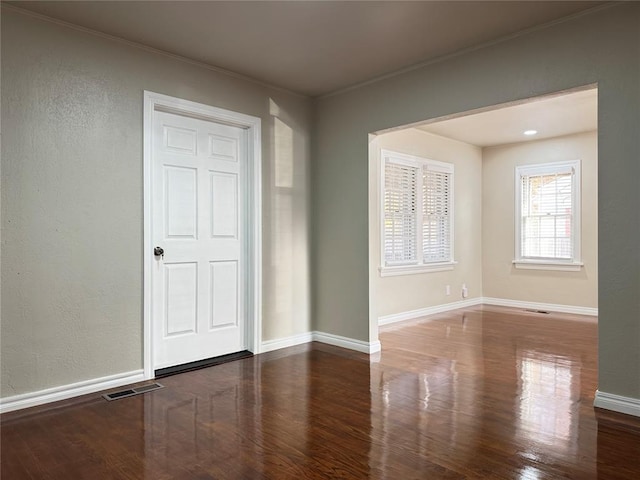 spare room with hardwood / wood-style floors and ornamental molding