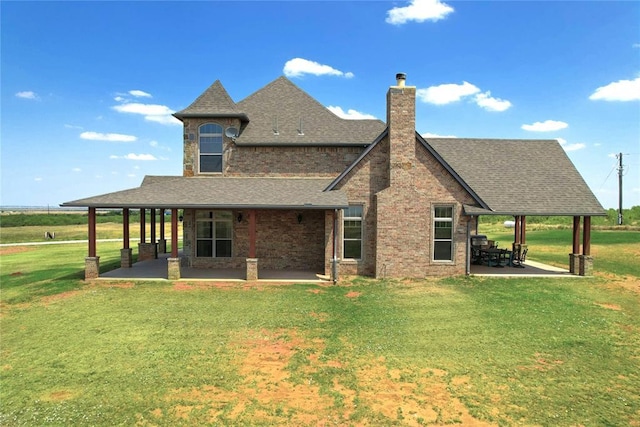 rear view of property with a patio area and a lawn