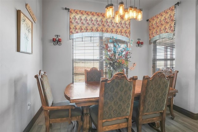 dining area featuring a chandelier, hardwood / wood-style flooring, and plenty of natural light