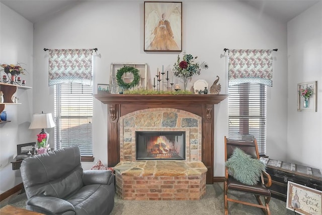 living area with carpet and a brick fireplace