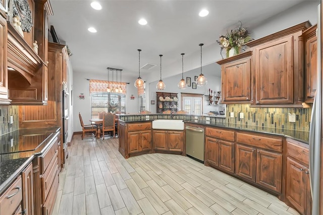 kitchen with dishwasher, sink, kitchen peninsula, decorative light fixtures, and decorative backsplash