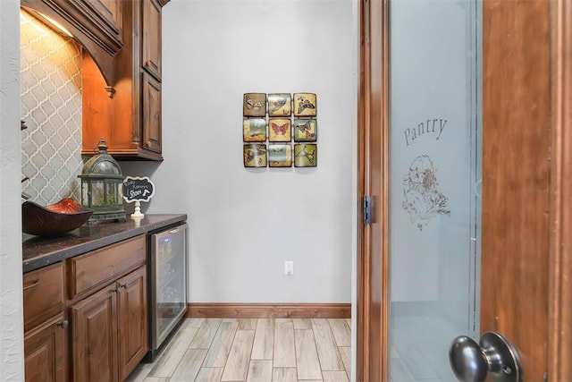 interior space with wine cooler and light hardwood / wood-style flooring