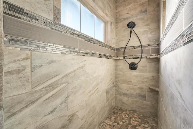 bathroom with tiled shower