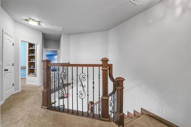 hall featuring carpet flooring and built in shelves