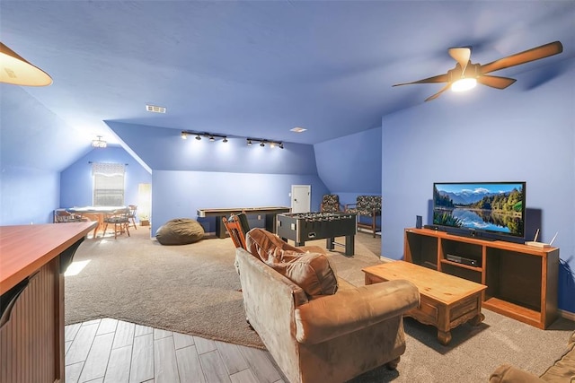 interior space with ceiling fan and vaulted ceiling