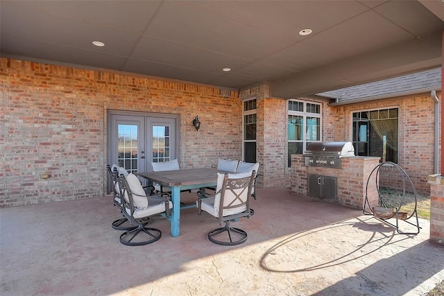 view of patio featuring area for grilling, exterior kitchen, and french doors