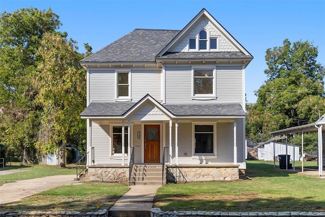 124 N Pesotum Ave, Shawnee, OK 74801 - victorian-style house with a front yard, a shingled roof, and a porch