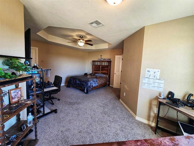 bedroom featuring a raised ceiling, carpet, visible vents, and baseboards