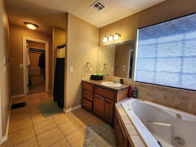 full bathroom with a textured wall, visible vents, a textured ceiling, and tile patterned floors