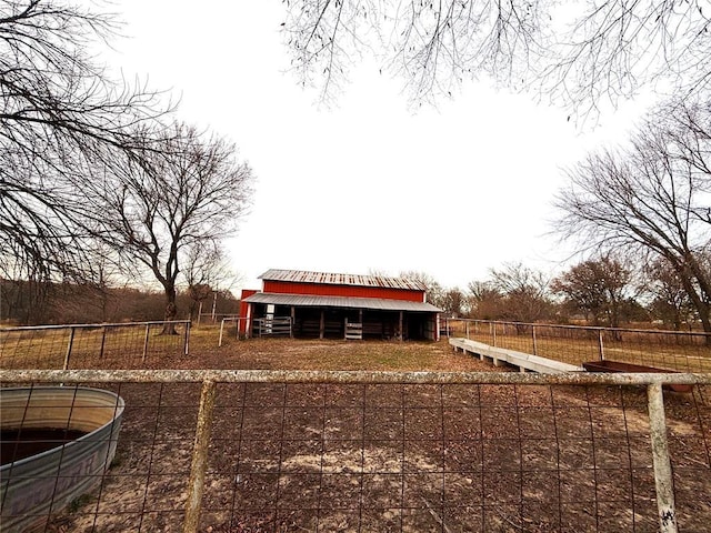 view of yard featuring an outbuilding, fence, and a pole building