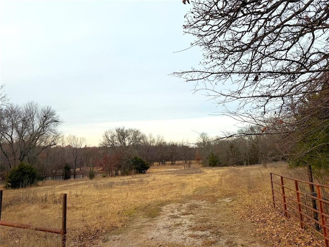 view of yard featuring a rural view and fence