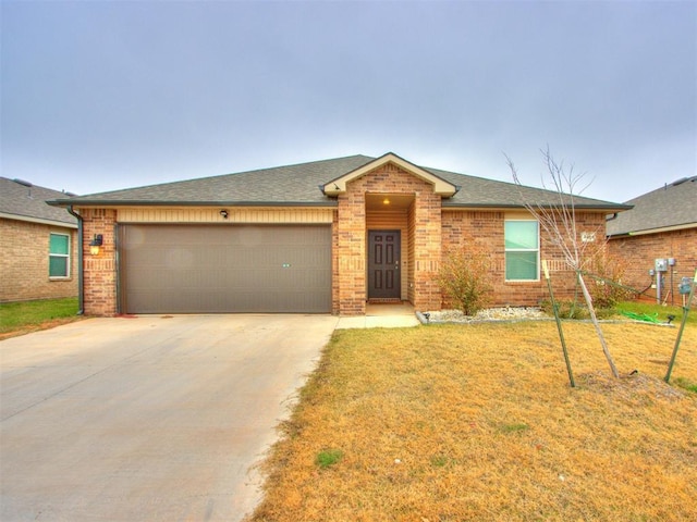 single story home featuring a front lawn and a garage