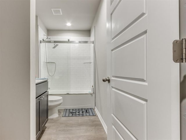 4408 Moonlight Rd, Mustang, OK 73064 - bathroom with enclosed tub / shower combo, vanity, wood finished floors, and recessed lighting