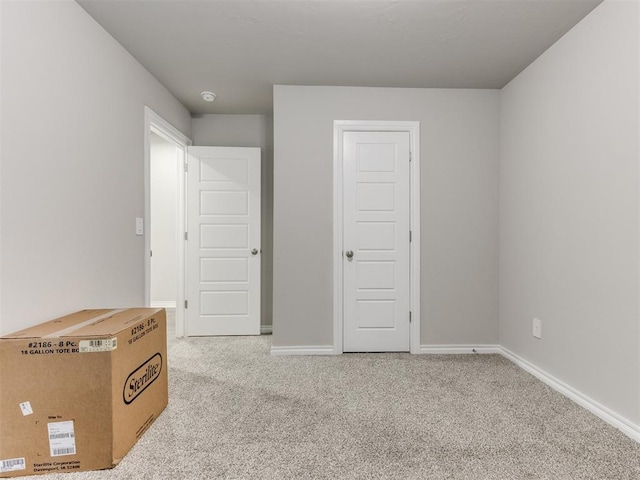 unfurnished bedroom featuring light colored carpet