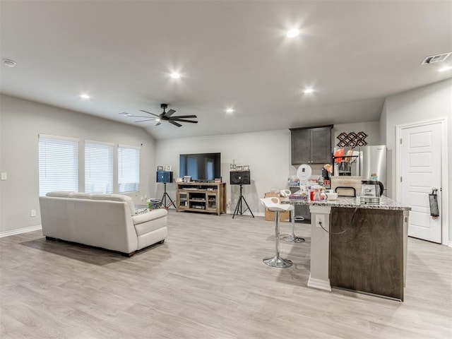 living room with ceiling fan and light hardwood / wood-style floors