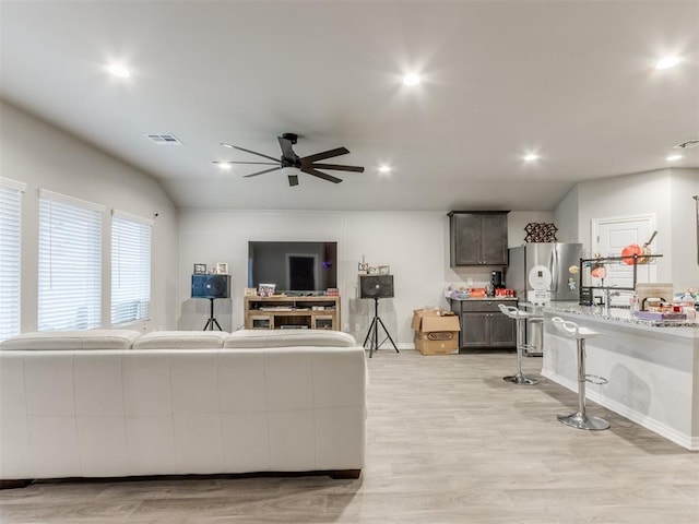 living room featuring ceiling fan and light wood-type flooring