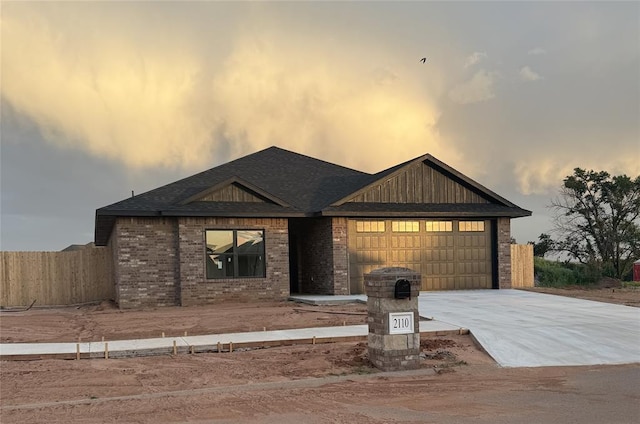 2110 Valley View Rd, Weatherford, OK 73096 - view of front of house featuring a garage, concrete driveway, brick siding, and a shingled roof