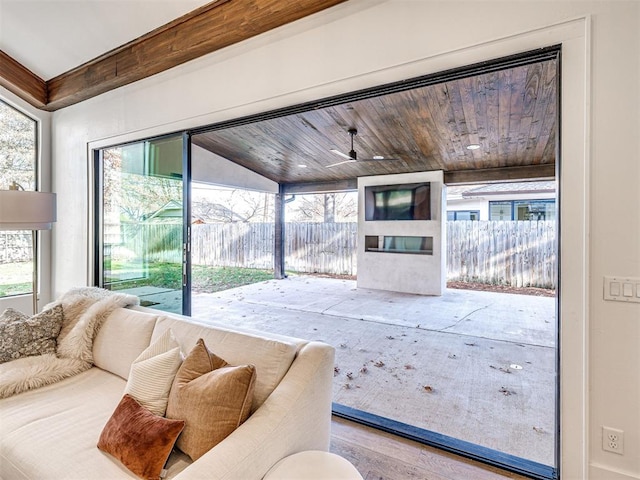 living room with wood ceiling, plenty of natural light, and hardwood / wood-style floors