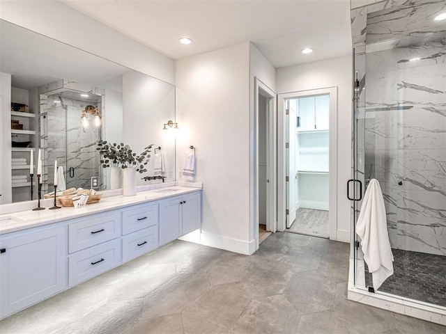 bathroom with vanity and a shower with shower door