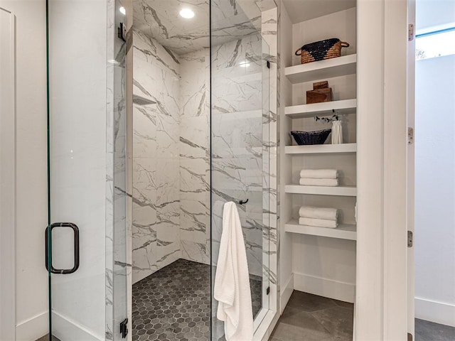 bathroom featuring a shower with shower door