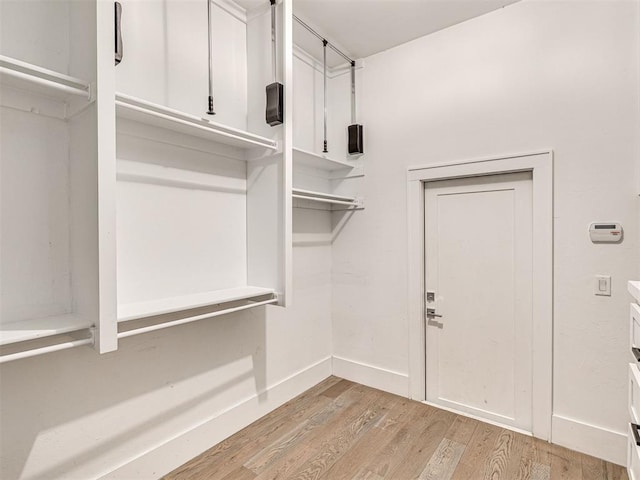 spacious closet featuring light hardwood / wood-style flooring