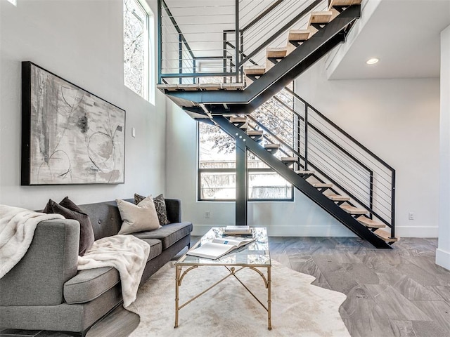 living room featuring a towering ceiling