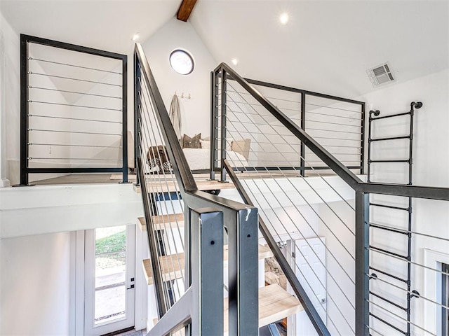 stairway with lofted ceiling with beams