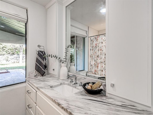 bathroom featuring vanity and a shower with shower curtain