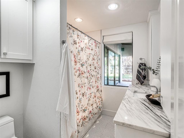 bathroom featuring vanity, curtained shower, and toilet