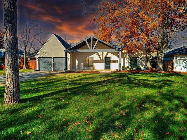 view of front of house featuring a garage and a yard