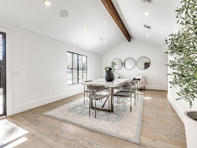 dining space with vaulted ceiling with beams and light wood-type flooring