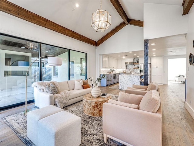 living room with a healthy amount of sunlight, beam ceiling, and a chandelier